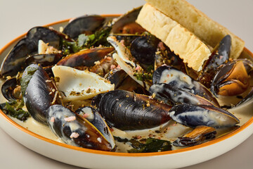 Wall Mural - Gourmet Mussels in Creamy Sauce on Elegant Plate with Crisp Bread