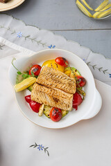 Wall Mural - Grilled Cod Fillet with Tomatoes and Zucchini in Rustic Light