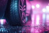 Close-up of a car tire on a wet street illuminated by colorful neon lights at night