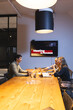 © Wavebreak Media - Diverse colleagues discussing project at conference table, late-night business meeting, at office