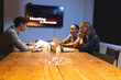 © Wavebreak Media - Discussing documents in conference room, diverse professionals, late-night meeting, at office