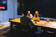 © Wavebreak Media - Business diverse professionals discussing project strategy at night meeting in office