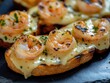 © Oleg - A mouthwatering appetizer featuring shrimp, toasted bread with cheese and a savory cream sauce.