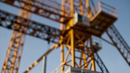 Aufkleber - Construction engineers wearing safety vests and helmets discuss near cranes at a building site, with close ups of crane details in slow motion