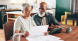 © peopleimages.com - Mature, interracial couple and documents with tablet for financial discussion, planning or expenses at home. Man, woman or mortgage with paperwork or technology for payment due, finance or bills