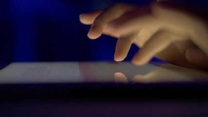 Girl Typing on Touch Screen Digital Tablet at Night. Hands of Person Typing Article Text or Document on Mobile Computer Close Up. Human Hands Typing Text Message Email on Tablet Touch Screen Keyboard.
