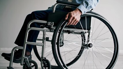Poster - Office worker sitting in wheelchair propelling forward in slow motion, isolated on white background, symbolizing inclusivity and accessibility in the workplace