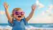 © Quality One   - joyful toddler girl wearing pink sunglasses, celebrating at beach with arms raised. bright blue sky and ocean create cheerful atmosphere
