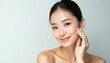 © Vadym - Close up of perfect beauty face of young beautiful Asian woman gently touches her face. Facial cream advertising with generative ai. Clean, radiant, hydrated skin care concept for spa and cosmetology.