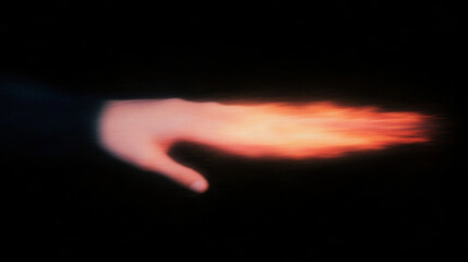 Poster - Abstract motion blur of hand with fiery glow against black background