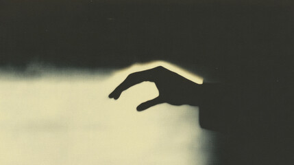 Poster - Dramatic silhouette of hand reaching in soft light for artistic touch