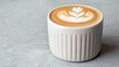 © MAKASIHMAS SIDNEY - Latte art in a ceramic cup on a gray surface.  Possible use for a coffee shop or food blog