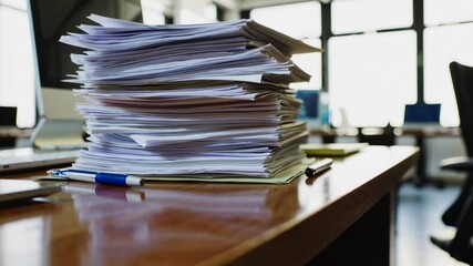 Poster - Office work stress is depicted by a large stack of papers on a desk, captured in a slow motion sequence, highlighting the overwhelming workload and potential for burnout