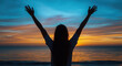 Silhouette of Woman Celebrating at Sunset by the Ocean 
