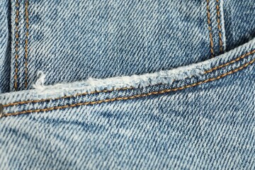 Sticker - Stylish light blue jeans with pocket as background, top view