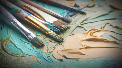 Wall Mural - Artist's palette with many brushes and mixed paints, closeup