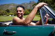 © Leffy/peopleimages.com - Happy, car and man on road trip in convertible for vacation, getaway or holiday with fun. Outdoor, adventure and male person driving vehicle in summer for discovery on weekend journey or travel.
