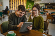 © Miljan Živković - couple learn together and prepare exam on digital tablet at cafe