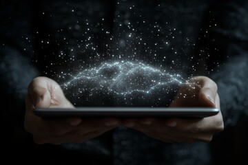 Poster - Creative hands holding a tablet emitting sparkling light against a dark background at night