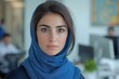 © MarisaSp - confident young woman in blue hijab at modern office workspace, Arabian businesswoman portrait