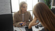 © Krakenimages.com - Women discussing business ideas in a modern office setting, highlighting their professional roles and collaborative efforts in a caucasian workplace environment.
