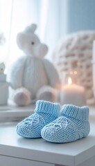 Wall Mural - Delicate close up of baby booties on table against a soft white background in pastel blue hues