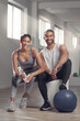 © peopleimages.com - Exercise, medicine ball and portrait of couple in gym together for bonding, training or workout. Break, fitness or smile with happy man and woman athlete in health club for challenge or performance