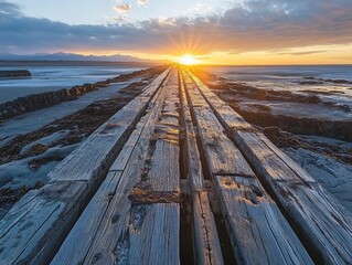 Aufkleber - Sunset over a weathered wooden jetty extending into the ocean.