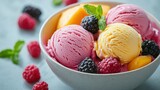 Bowl of ice cream topped with assorted fruits and fresh mint leaves on a wooden table