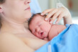 © peopleimages.com - Childbirth, motherhood and woman with newborn, healthcare or love for baby on bed, labor or healthy. Clinic, hug and temperature regulation with skin contact, touch or new parent with care for infant