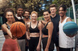 © peopleimages.com - Fitness, portrait and people with smile, basketball and athlete with training, wellness and practice. Group, healthy and friends with goals, court and competition with support, outdoor and players