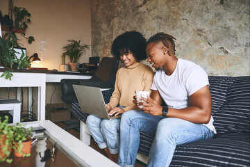 Poster - Happy, home and couple on sofa on laptop for online shopping, internet and digital subscription. Living room, relax and African man and woman on computer for booking holiday, travel and accommodation
