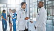 © peopleimages.com - Men, doctor or surgeons with discussion at hospital for proposal, medical feedback or idea. Male people, colleagues or healthcare employees talking with health advice for procedure or clinic strategy