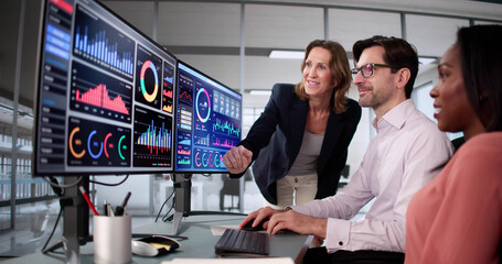 Poster - Business students analyzing data on computer screens