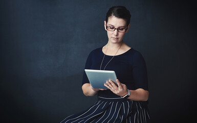 Poster - Woman, web designer or studio with tablet for online or digital marketing on a dark background. Female person, model or creative employee with technology or glasses for network or app on mockup space