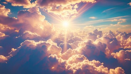 Poster - Vibrant dramatic sunrise over fluffy clouds in a blue sky with rays of sunlight creating a picturesque natural scene