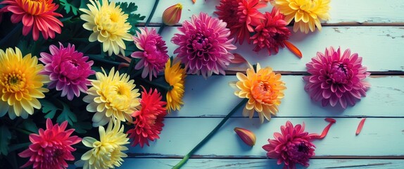 Poster - Colorful assorted flowers on a rustic wooden surface with scattered petals and green leaves