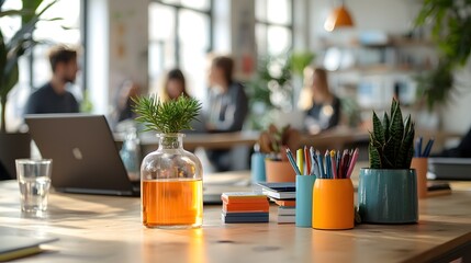 Poster - Blurred office scene showcasing a collaborative workspace with a laptop various stationery supplies and a plant creating a cozy and professional atmosphere for teamwork and productivity
