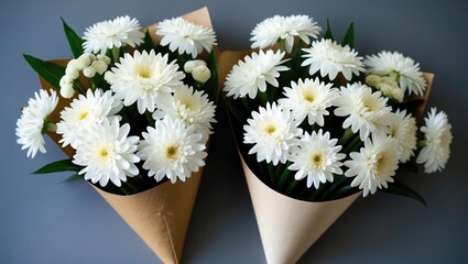 Poster - Two bouquets of white daisies arranged in cone-shaped paper packaging on a gray background