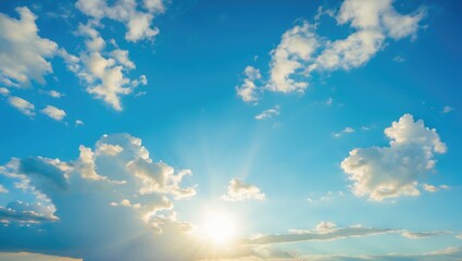 Poster - Bright summer sky with soft white clouds illuminated by sunlight, featuring clear blue background and ample copy space for text.