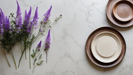 Poster - Purple flowers beside ceramic plates on a textured surface creating a rustic and elegant table setting scene