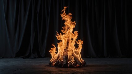 Poster - Fire flames rising from a log on dark background with black drapery creating an atmospheric and dramatic effect