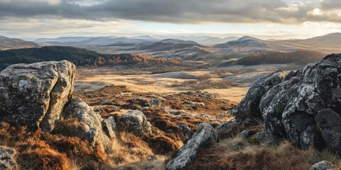 Aufkleber - Stunning highland landscape view featuring rocky outcrops and golden grasslands under a dramatic sky emphasizing tranquility and natural beauty