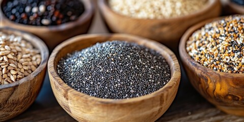 Poster - Vibrant display of nutritious chia quinoa and flax seeds in rustic wooden bowls arranged in a circular pattern showcasing rich earthy tones