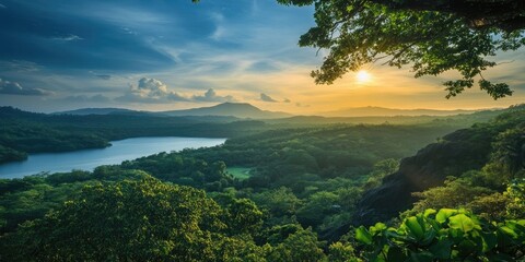 Aufkleber - Lush green landscape with a serene lake at sunset, warm golden light reflecting on water, distant mountains under a blue sky with clouds.