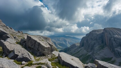 Aufkleber - Dramatic cloudy sky over rocky mountain landscape with distant peaks and lush greenery in tranquil natural setting.