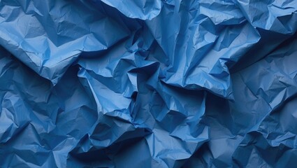 Poster - Crumpled textured blue paper background with varying shades and depth for use in design and artistic projects