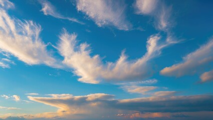 Poster - Dynamic cloud formations against a clear blue sky during sunset with soft pastel hues and varied cloud textures