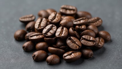 Poster - Close up of dark roasted coffee beans arranged on a textured gray background showcasing their rich color and unique shapes.