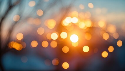 Poster - Blurred background with warm golden and orange bokeh lights during sunset against a soft blue sky and silhouetted branches in the foreground